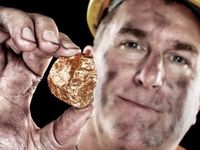 Gold miner holding a nugget