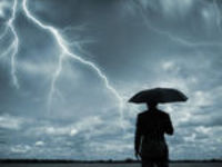 man with umbrella and lightning