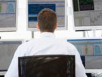 Trader looking at multiple screens