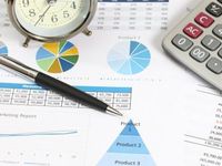 Calculator and pen on business chart