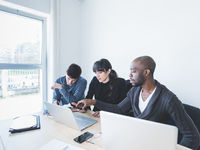 Millennials Discussing Around Computers