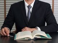 Man in Suit Reading a Book