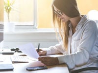 Business woman reading a sheet of paper 