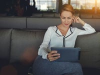 Business woman reading from her tablet 
