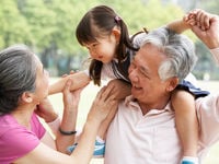 Grandparents playing with their granddaughter. 
