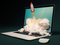 A rocket shooting out of a laptop. 