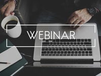 A business man on his computer and the text webinar. 