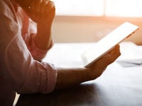 Man Reading Tablet